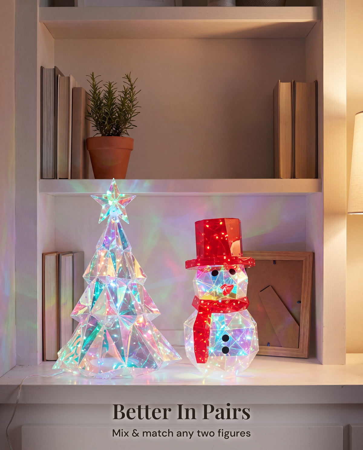 The tree and snowman lit together on a bookshelf