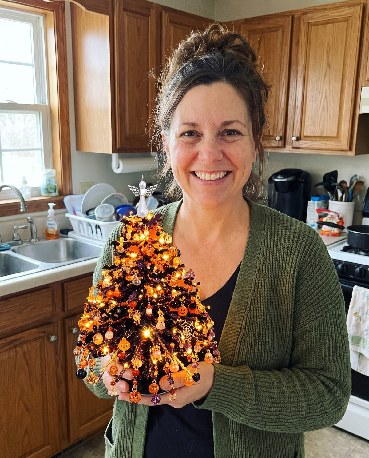 A finished Halloween tree held up in a kitchen